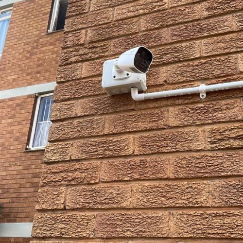 Camera installed at a block of flats or at an apartment complex to monitor the side of the building.